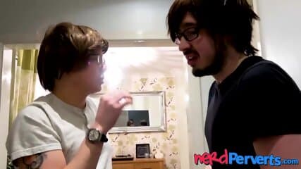 Curvy slut blowing two nerd producers dicks